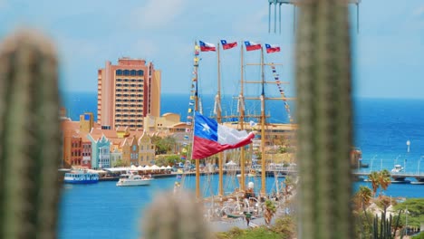 Tall-ship-moored-flying-the-Chilean-Colors-pan-with-cacti-in-the-foreground