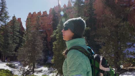 Girl-woman-hiker-enjoying-the-red-rocks-formation-and-snow-near-Bryce-Canyon-in-southern-Utah