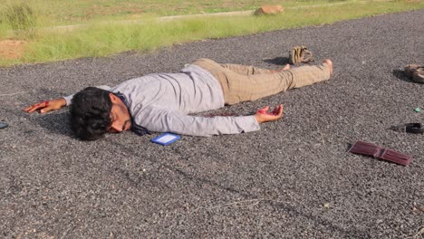 Concept-of-road-accident-of-crime-scene,-Pan-view-of-young-adult-man-dead-body-on-the-road