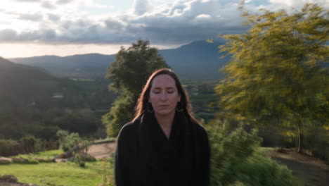 Hyper-Lapse-zooming-into-a-meditating-womans-face,-she-opens-her-eyes-as-camera-stops