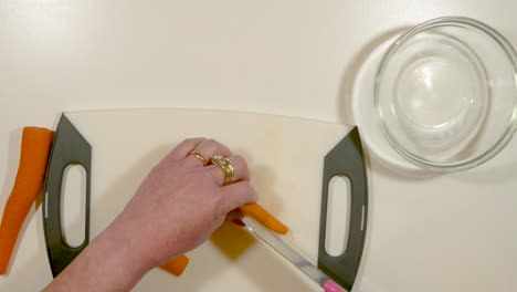 Woman's-hands-chopping-carrots---speed-ramp-up-and-down