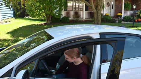 Soon-to-be-driver,-Madelyne,-enters-the-car-and-smiles-at-the-camera