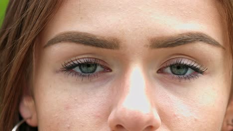 Close-up-shot-of-a-young-woman's-piercing-green-eyes