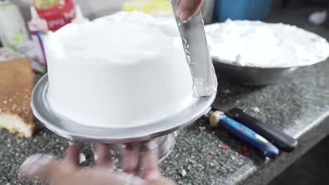 Close-Up-Of-Professional-Chef-Squeezes-Cream-And-Makes-Cake-Base-4K