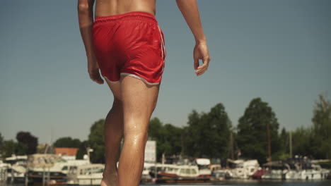 Young-man-diving-off-front-of-yacht-into-water-on-summer-day-1