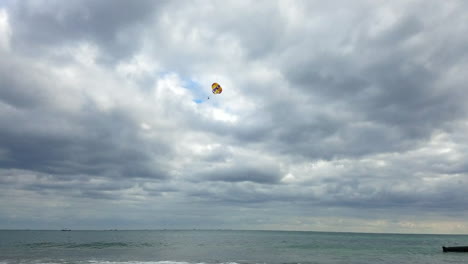 Parasail-Behind-Boat-And-Ocean-Horizon-During-A-Cloudy-Day-In-Mexico