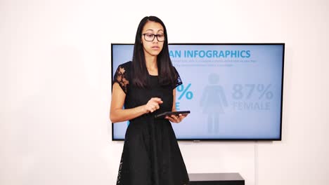 Young-brunette-businesswoman-displays-digital-presentation-at-office