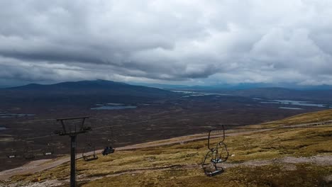 Tilting-drone-shot-of-mountain-skilift,-scottish-highlands