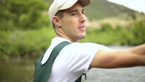 Slow-Motion-Shot-of-a-Caucasian-male-fisherman-casting-his-hook-while-Fly-Fishing-9