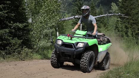 Shot-of-a-rider-driving-his-ATV-off-of-a-jump-and-catching-a-little-air