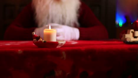 Burning-Candle-On-Santa's-Table.Video-Dolly-Truck-Right