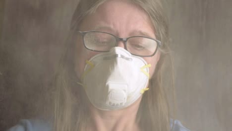 Head-shot-of-woman-wearing-disposable-dust-mask-in-toxic-environment