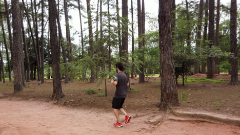 Caucasian-man-running-on-the-forest-trail