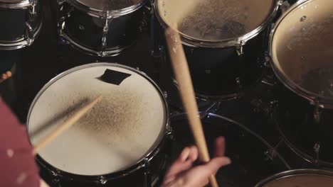 Attractive-Young-Man-Drummer-Playing-His-Drum-Set-and-Practicing-while-Singing---Close-Up-Shot