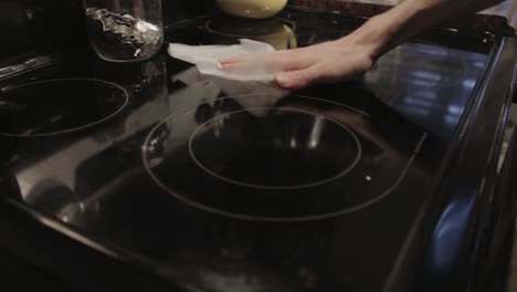 Wiping-The-Clear-Glass-Gas-Stove-With-Wet-Wipes---Close-Up-Shot