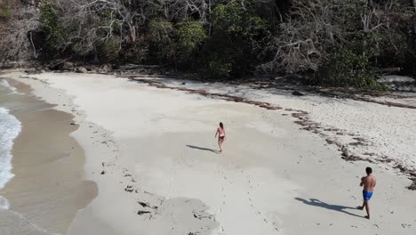 Panama-in-February-drone-shoots-Contadora-Island-guys-walking,-recording-1