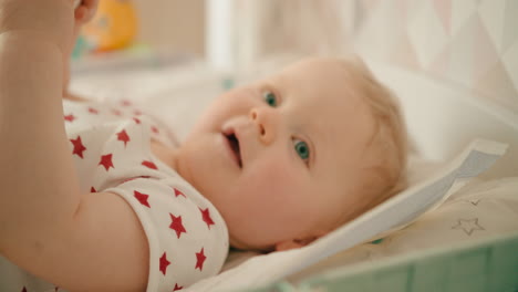 Cute-adorable-baby-girl-smiling-on-the-changing-mat