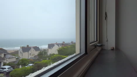 Rain-Flowing-Down-a-Glass-Window-with-an-Ocean-View