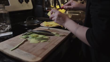 A-Person-Cutting-Mango-Fruit-Using-Sharp-Knife---Closeup-Shot