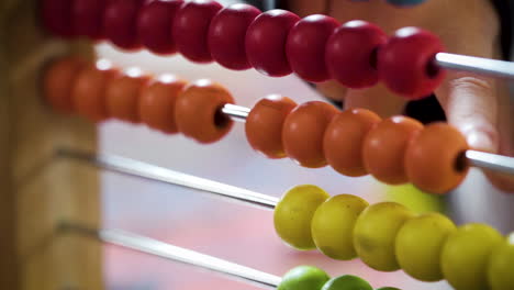 Young-boy-counting-with-a-colourful-abacus-in-slow-motion