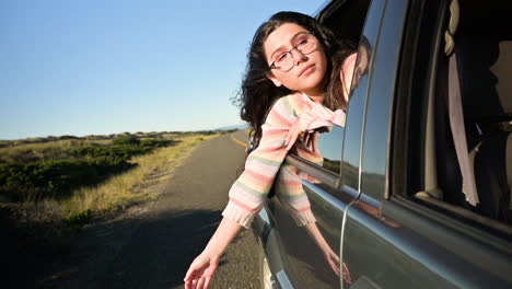 Girl-hanging-out-of-car-window-in-slow-motion
