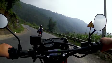 Chest-mounted-view-of-a-man-riding-a-motorcycle-along-winding-roads-in-the-stormy-weather-of-the-northern-mountains-in-Vietnam