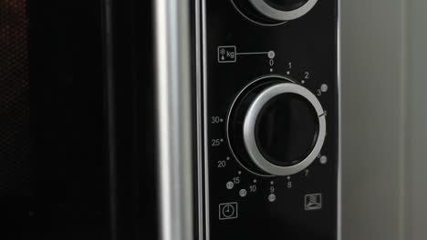 Setting-microwave-timer-to-four-minutes-and-turning-microwave-off---close-angled-shot
