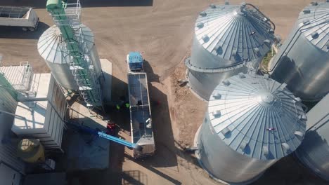 Drone-aerial-view-of-a-trailer-being-loaded-for-shipment-at-an-agribusiness-that-exports-cover-seeds-located-in-Nebraska-USA