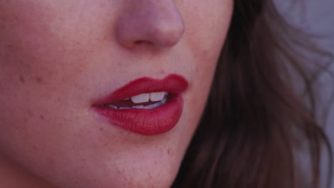 Slow-motion-close-up-of-a-beautiful-woman's-red-lips-panning-up-to-her-brown-eyes