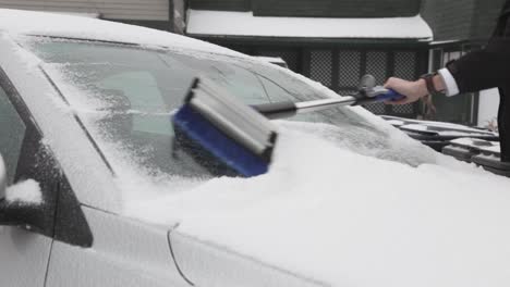 A-Man-Clearing-Away-The-Ice-Covering-The-Windshield-Of-His-Car---Close-Up-Shot