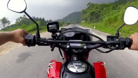 Chest-mounted-view-of-a-man-riding-a-motorcycle-along-winding-roads-in-the-stormy-weather-of-the-northern-mountains-in-Vietnam-2