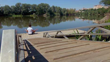 Man-meditating-at-the-riverbank