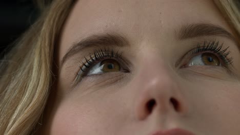 Close-up-shot-of-a-young-woman's-brown-eyes,-blinking-in-slow-motion
