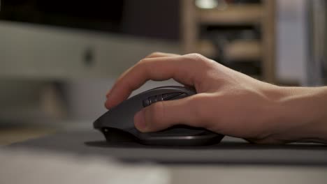 Hand-Moving-The-Computer-Mouse-On-The-Mouse-Pad---closeup-shot