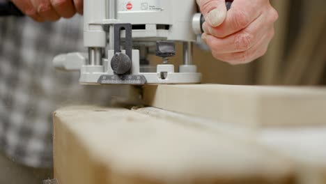 Skilled-artisan-milling-wood-shelf-with-rounding-cutter
