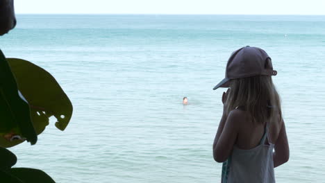 Blonde-Caucasian-girl-with-homesickness-looking-out-Into-tropical-ocean,-ready-for-color-grading