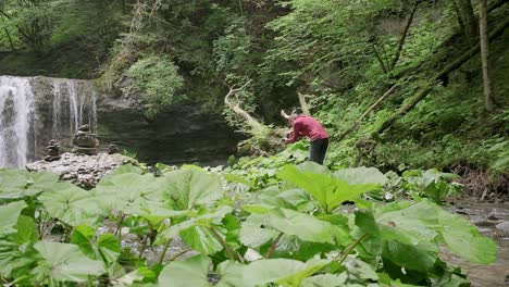 Photographer-wearing-a-red-jumper-walks-around-trying-to-find-a-compositon-for-the-waterfall