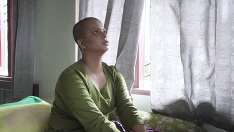 Cancer-patient-bald-Asian-girl-is-sad-and-crying-at-home,-after-chemotherapy