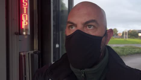 Male-opening-car-wash-workplace-wearing-PPE-corona-virus-face-mask-at-stop-sign-looking-ahead