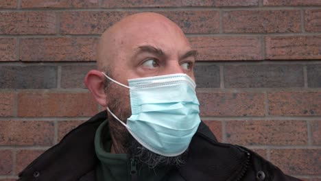 Male-security-guard-adjusting-protective-corona-virus-medical-PPE-mask