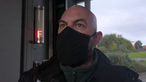 Male-opening-car-wash-workplace-wearing-PPE-corona-virus-face-mask-at-stop-sign-dolly-left