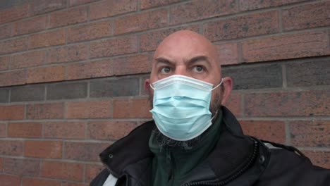 Male-guard-in-uniform-wearing-protective-corona-virus-medical-PPE-mask