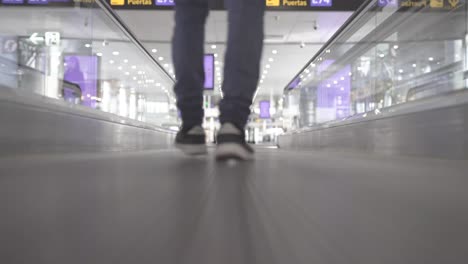 Traveler-walking-through-airport-hall,-low-angle-shot