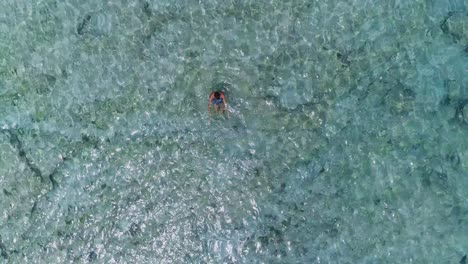 Bird's-view-of-young-man-enjoying-crystal-clear-water-in-Palms-island,-Lebanon
