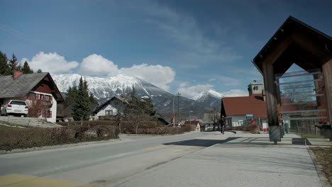 Riding-a-bike-through-the-village-of-Zazip-with-the-Karavanke-Alps-in-the-background-and-Stol-mountain