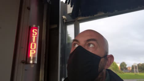Male-opening-car-wash-workplace-wearing-PPE-corona-virus-face-mask-at-stop-sign-handheld