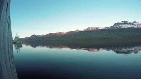 Beautiful-reflection-of-Sunrise-in-bay-in-Faskrudsfjordur-in-east-Iceland