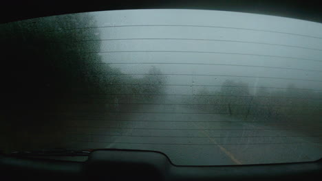 Foggy,-wet,-rear-window-of-a-moving-vehicle