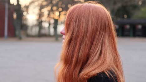 Close-Up-Profile-of-Young-Happy-Red-Haired-Woman-in-20s-in-Exterior,-Slow-Motion