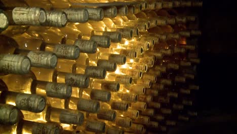 Tilt-from-bottom-to-top-of-hundreds-of-dusty-bottles-of-wine-in-a-wine-cellar